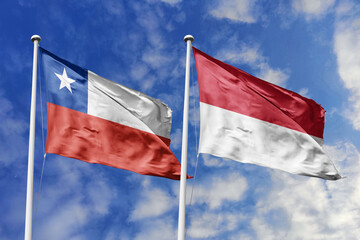 Flags of Chile and Indonesia Waving Together Under a Bright Blue Sky, Symbolizing International...