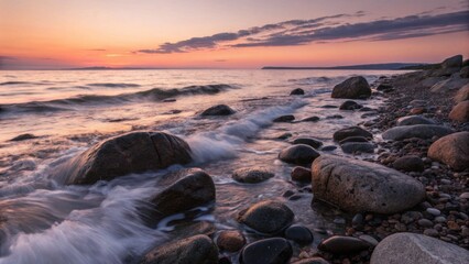 Serene ocean waves rolling over rocky shore at sunset  