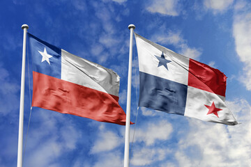 Chile and Panama flags waving under a bright sky, symbolizing unity and ties.