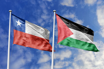 Chile and Palestine flags waving under a bright sky, symbolizing unity and ties. Red, white star of...