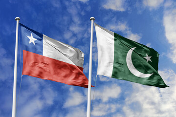 Chile and Pakistan flags waving under a bright sky, symbolizing unity and ties. Red, white star of Chile meets Pakistan's green with crescent and star, representing strength and peace.
