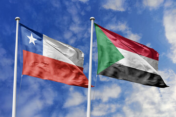 Chile and Sudan flags waving under a bright sky, symbolizing unity and cultural ties.Red, white...