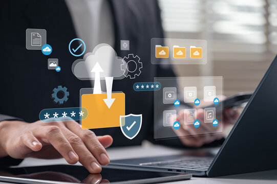 Cloud computing data transfer and secure storage system in business environment with man managing files on laptop and tablet for digital workflow and privacy protection across internet platforms