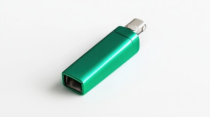 Green, rectangular tool with a metallic top sits on a white, reflective surface