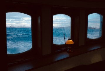 A cruise in Norway fijord, icy sea water and retro style window, This is a peaceful and cozy moment.