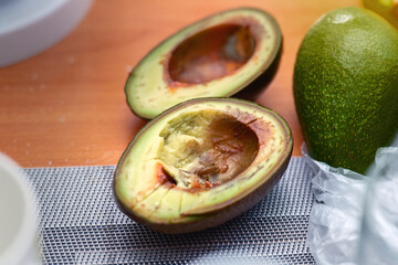 Cross-section of an overripe avocado cut in half, showcasing its soft texture and brownish flesh