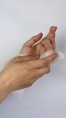 Close up of hands and white wet wipes keeping clean and hygienic. 