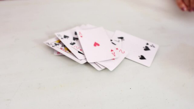 Senior man playing cards on white table