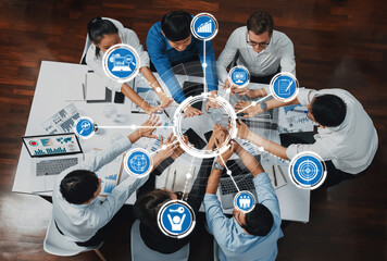 A diverse group of professionals engages in a collaborative meeting in a modern office. Technology...