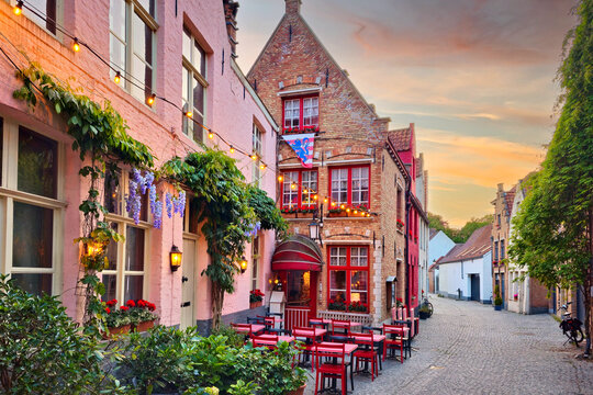 Quaint restaurant in the beautiful historic old town of Bruges, Belgium at sunset