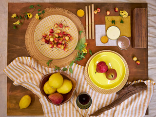 Top view flat lay of a summer-inspired moodboard and color palette arranged on a rustic wooden...