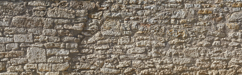 Rustic castle wall in Tuscany, italy, in panoramic format.
