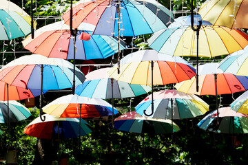 Colorful umbrellas hang above lively Istanbul street