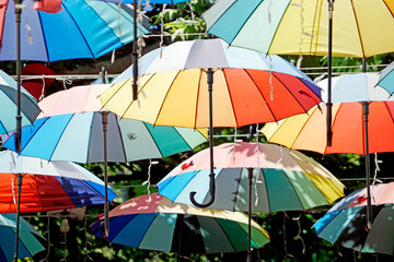 Colorful umbrellas hang above lively Istanbul street