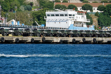 new military vehicles loaded in a harbor