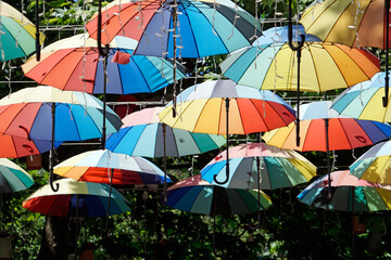 Colorful umbrellas hang above lively Istanbul street