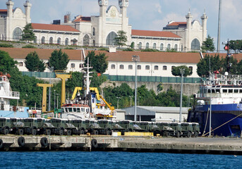 new military vehicles loaded in a harbor