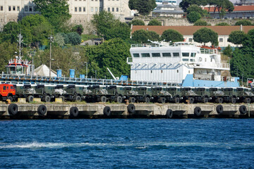 new military vehicles loaded in a harbor