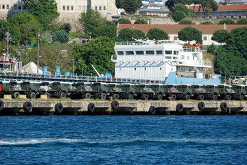 new military vehicles loaded in a harbor
