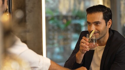 Serving welcome refreshing drink of fizzy tonic or soda garnish with slice lime at beverage counter...