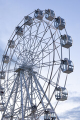 ferris wheel against the blue sky. attraction on the background of evening sky