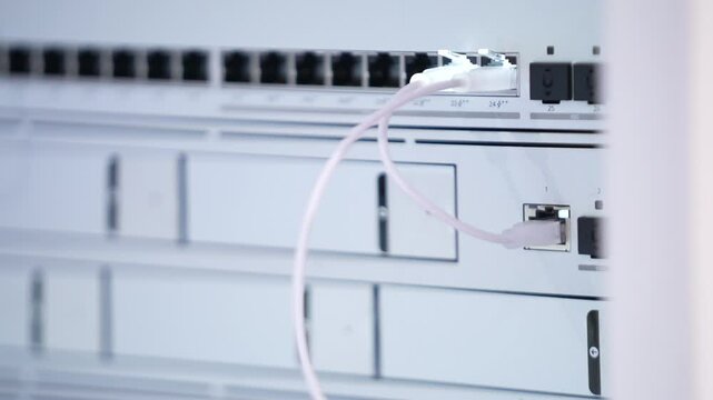 Switching hubs in IPS server room with cables and glowing lights