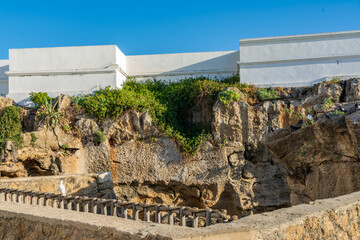 Scenic views of Tangier's seafront and old medina walls on a sunny day, showing a mix of coastal charm, public spaces, and historic Moroccan architecture