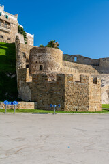 Scenic views of Tangier's seafront and old medina walls on a sunny day, showing a mix of coastal charm, public spaces, and historic Moroccan architecture