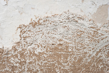 Old clay wall. Long cracks. Cracked plaster of a rural house