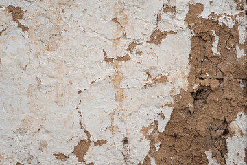 Old cracked clay wall. Deep cracks