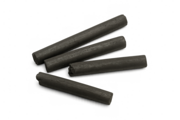 Four compressed charcoal sticks are lying on a transparent background, ready for artistic creation