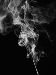 Black and white closeup of incense stick smoke in an abstract image.