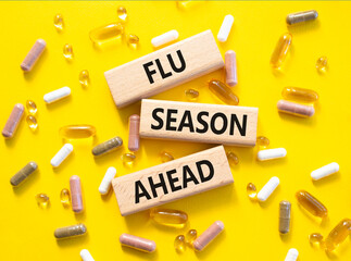 Flu Season Ahead symbol. Concept word Flu Season Ahead on wooden blocks. Beautiful yellow...