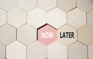 Now vs Later symbol. Concept word Now vs Later on wooden comb puzzle. Beautiful pink background....