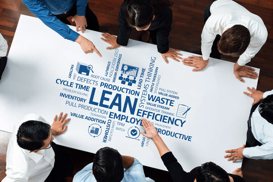A diverse group of professionals collaborates around a whiteboard, focusing on lean management concepts, efficiency strategies, and waste reduction in a corporate setting. Amity