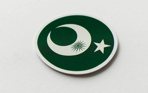 Close-up view of a beautifully crafted Pakistan flag-themed sticker with intricate green and white decoration. Generative AI.