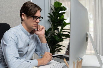 Smart marketing communication manager working on pc and laptop for creating online social media...