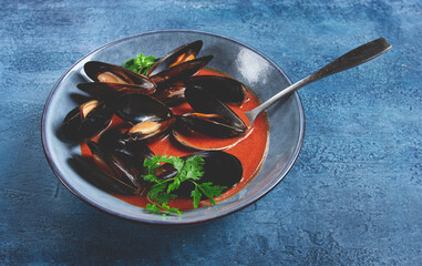 Fra Diavolo mussels, mussels in tomato sauce, Italian dish, on a blue background, homemade, no...