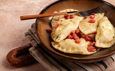 Dumplings, with fried prosciutto, a traditional dish of Polish cuisine, dumplings, top view, close-up, without people,