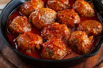 minced meat meatballs, in tomato sauce, in a cast-iron pan, homemade, no people,