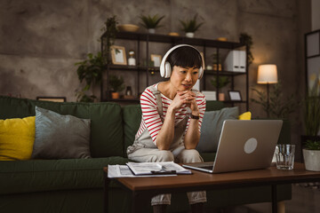 mature woman businesswoman have video call use laptop at home