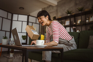 Japanese woman check box of received package or product at home