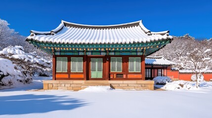 Fototapeta premium A traditional Asian building covered in snow, surrounded by winter landscapes under a clear blue sky, This serene image is ideal for winter tourism promotions, cultural articles
