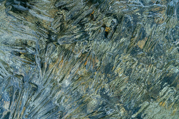 needles and crystals of melting transparent ice on the pebble shore of the northern Kolyma