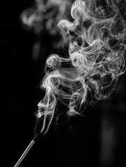 Black and white closeup of incense stick smoke in an abstract image.