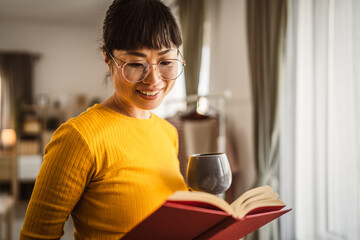 one female mature japanese woman read book at home