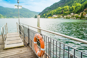 Spring view of Lake Lugano in the town of Caslano in the Swiss mountains