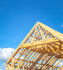 Partly assembled roof frame using stubbed eaves trusses comprised of a series of sloped wooden,...