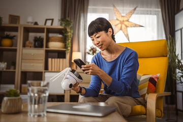 mature japanese woman adjust prepare home surveillance security camera