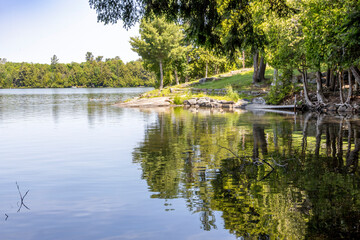 Serene view of Solitaire Lake in Huntsville, Ontario, showcasing tranquil waters and lush greenery on a peaceful summer day.